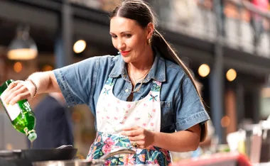 Alita Harvey Rodriquez in the MasterChef kitchen cooking and smiling.