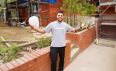 Adrian Portelli standing out the front of the My Reno Rules homes.