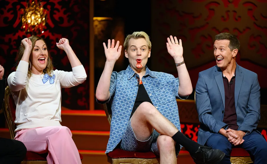Celia Pacquola and Joel Creasey have their hands up in the air while Rove McManus looks at them