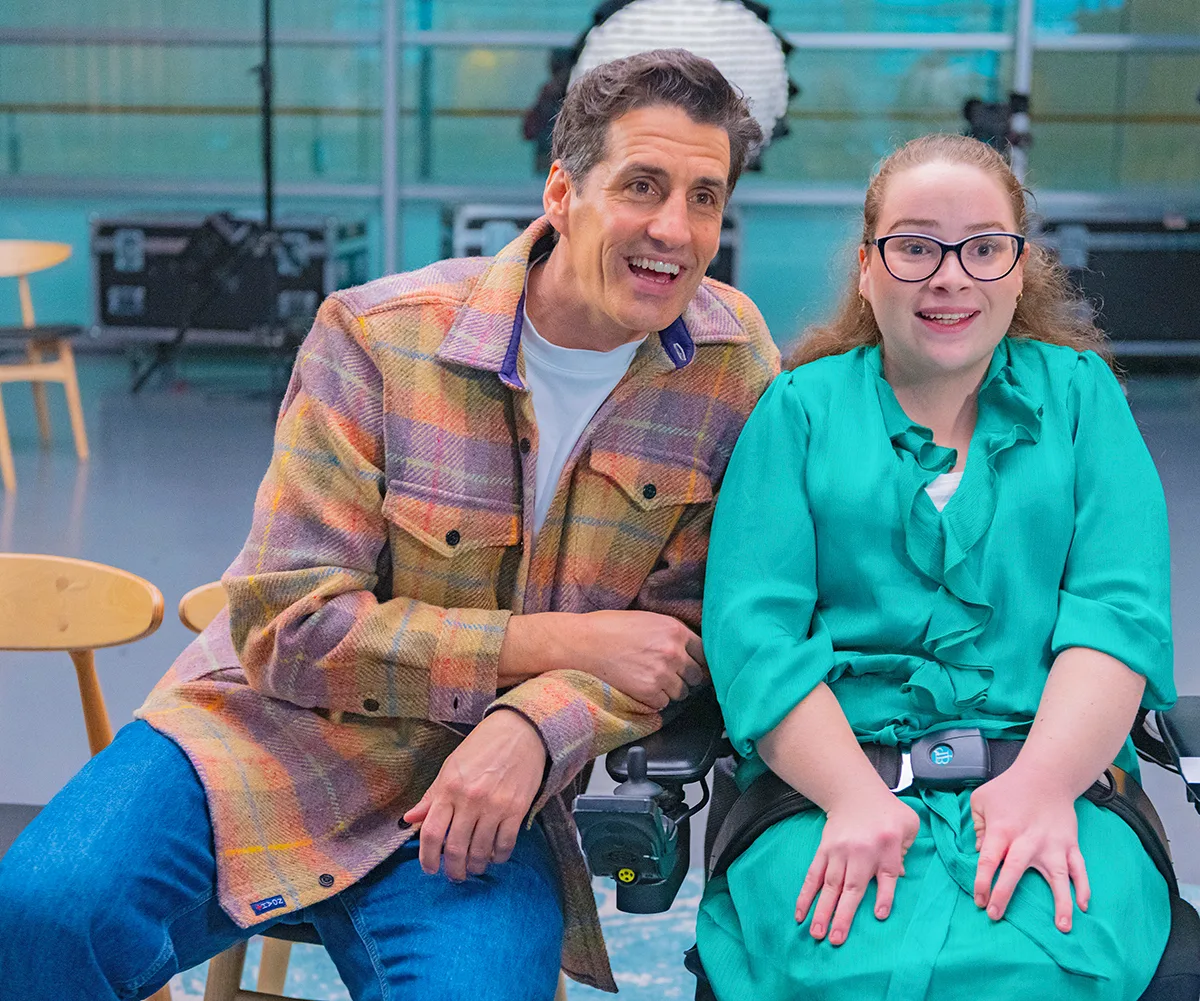 Andy Lee, in a checked shirt, sits next to Abbey, in a green dress
