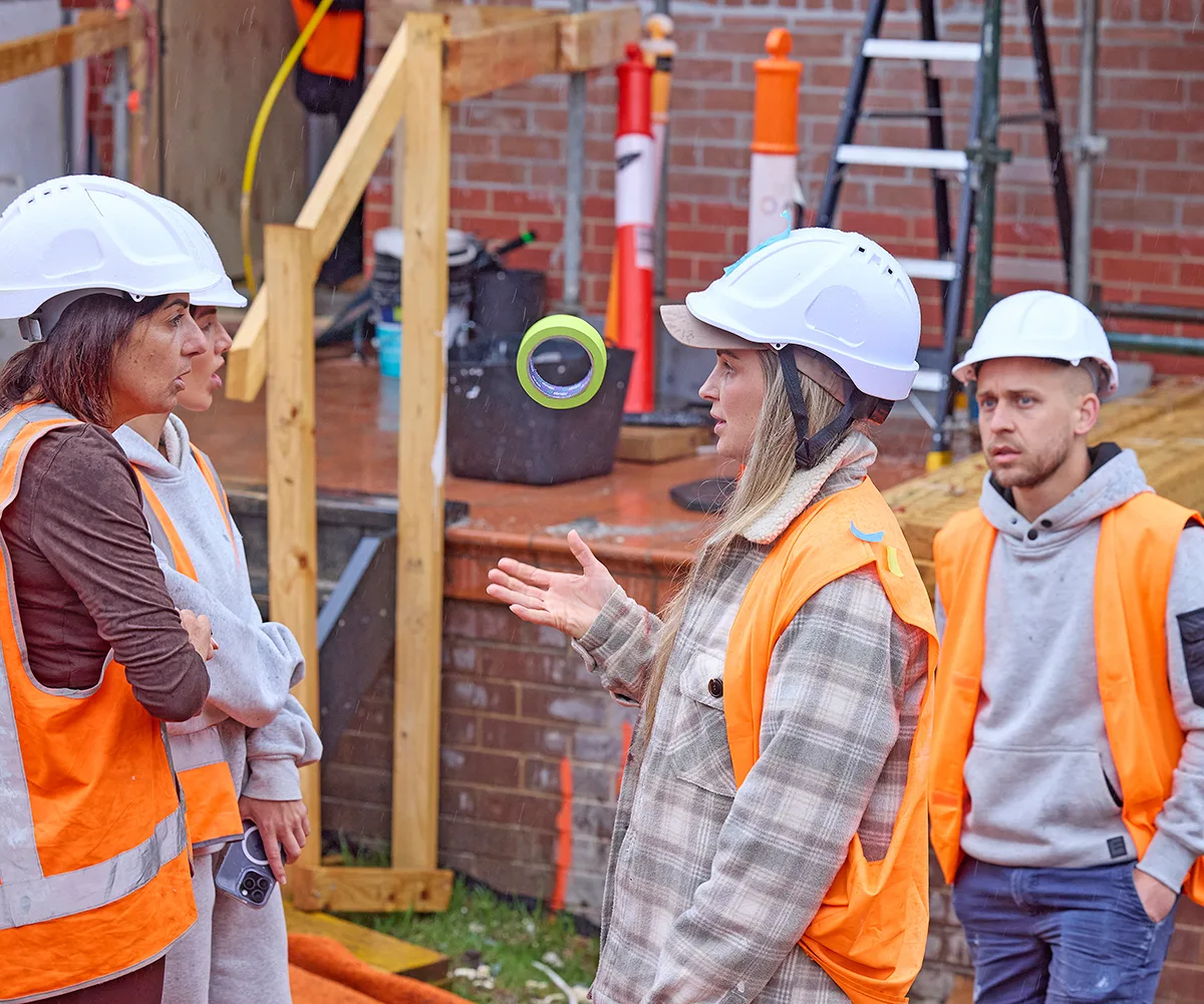 Emma and Michelle and Julia and Nathan in hi-vis in a heated exchange on site of My Reno Rules.