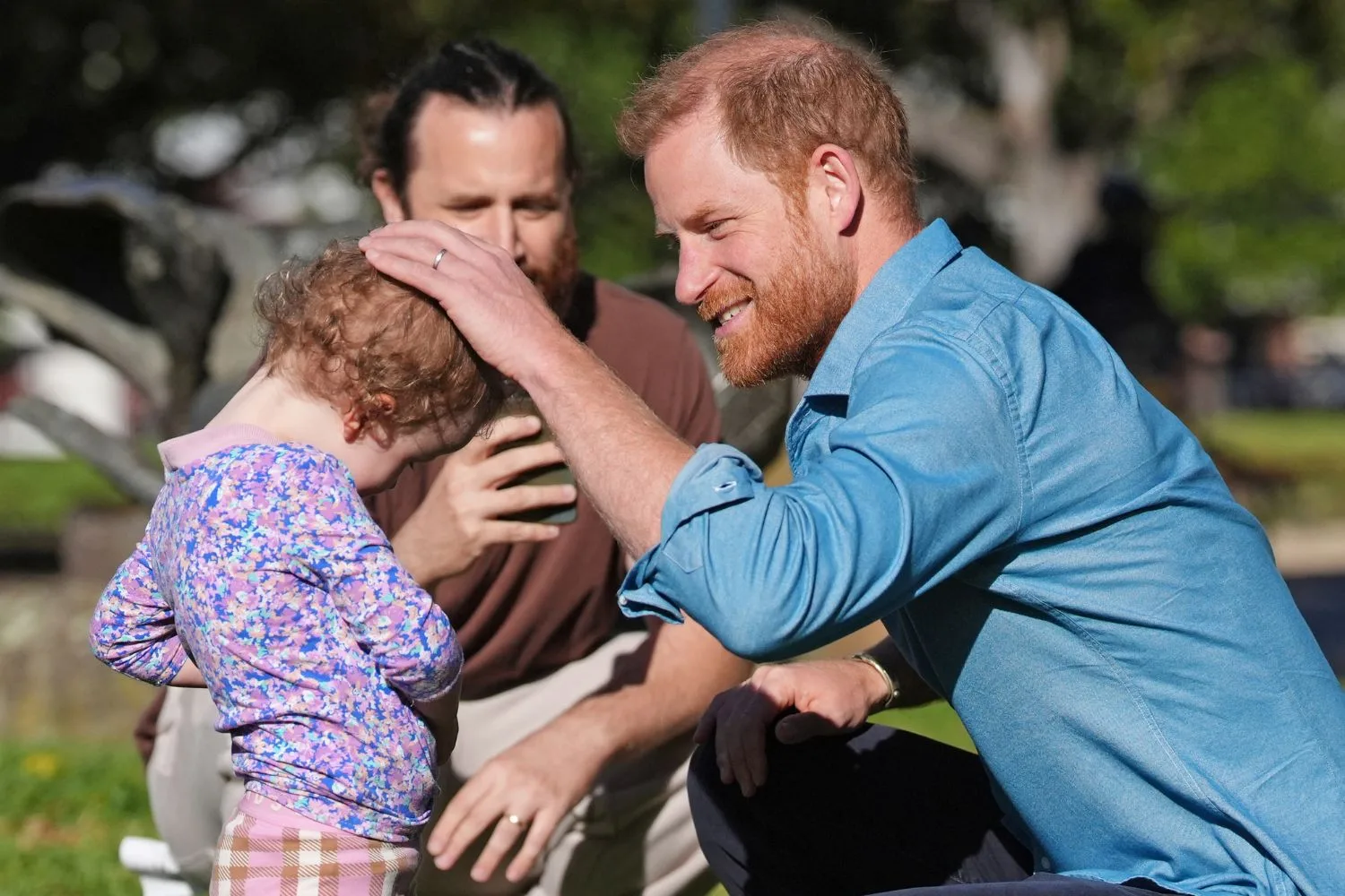 Prince Harry with a child in Australia