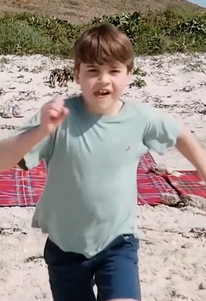 Prince Louis running on the sand