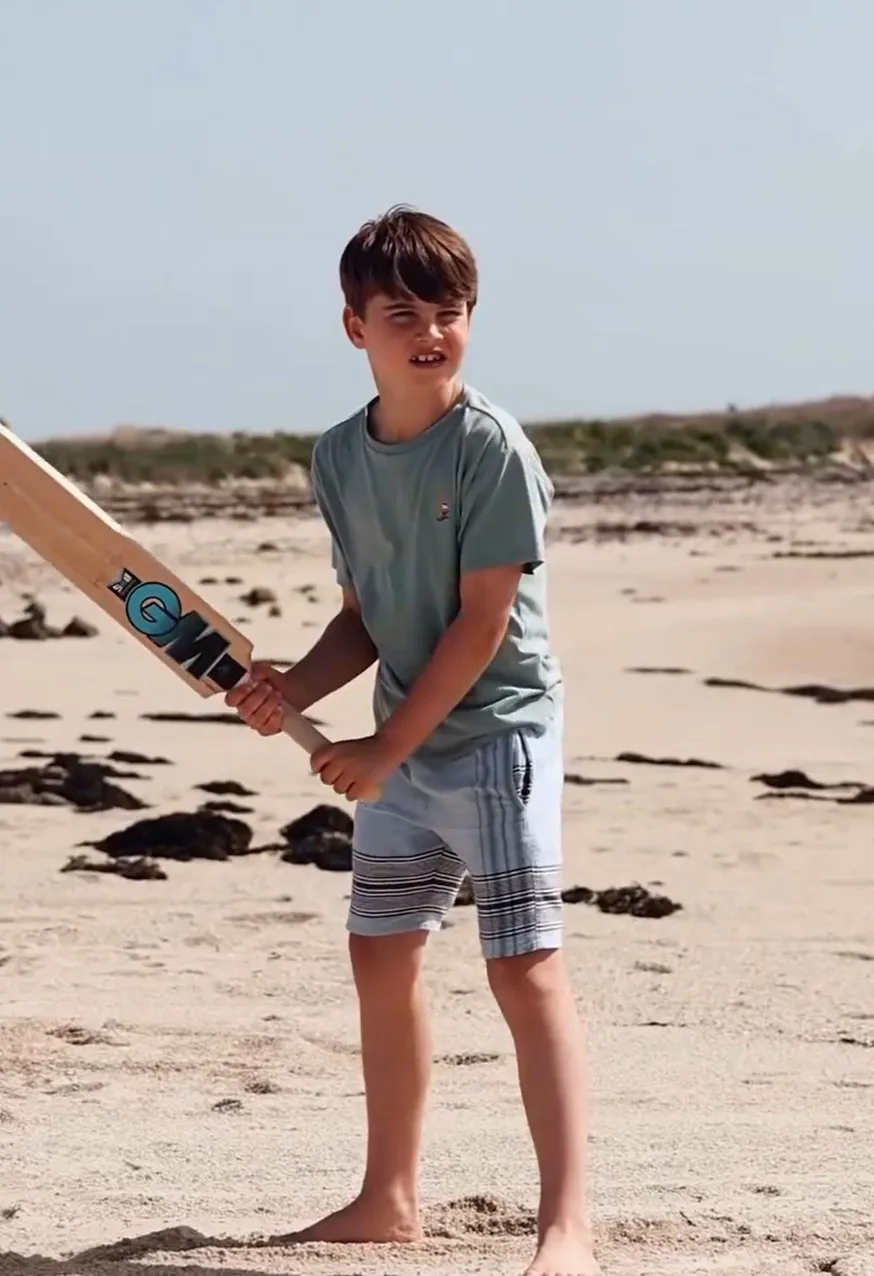 Prince Louis playing cricket on the beach
