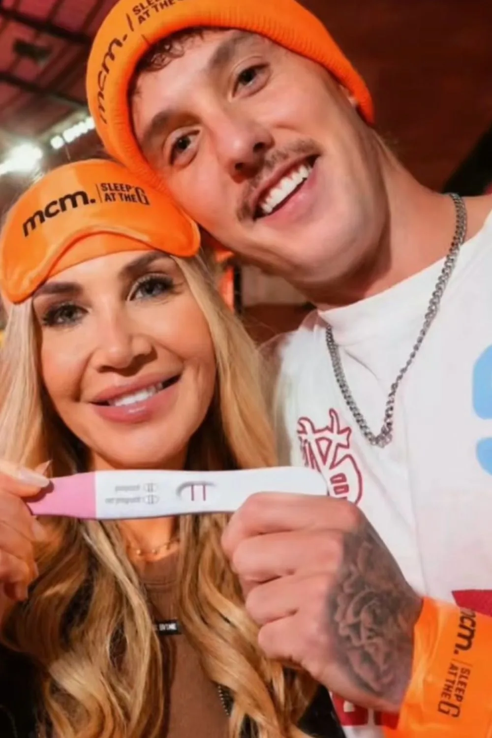 An AI photo of Gia Fleur and Alan Wallace holding a pregnancy test stick