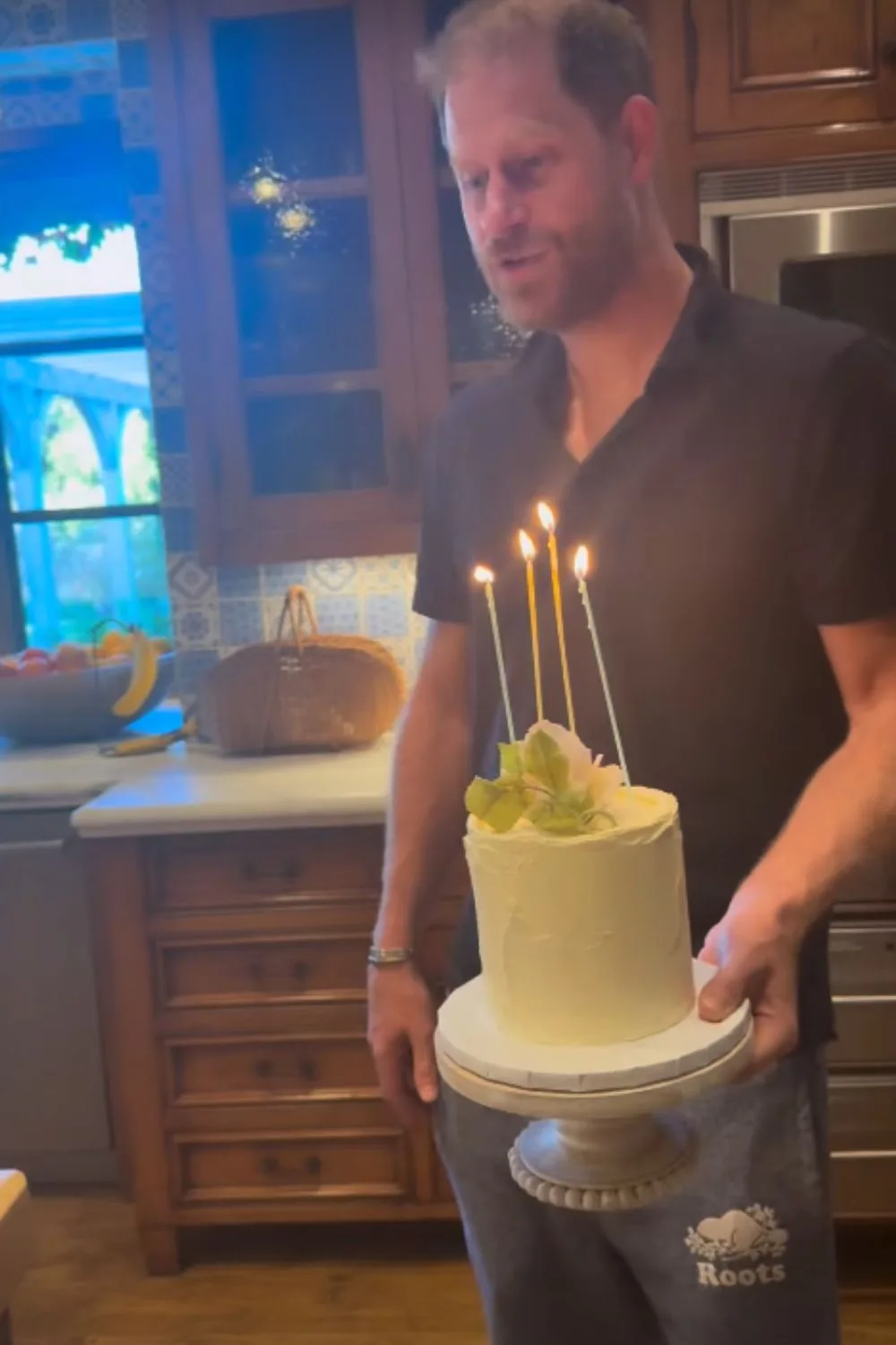 Prince Harry holding a cake