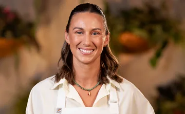 MasterChef Australia's Annabel Lloyd smiling in her apron in the MasterChef kitchen.