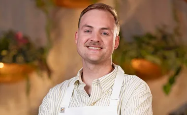 Casper Kenworthy smiling in the MasterChef Australia kitchen.