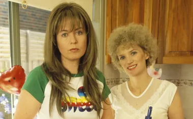 Kim stands next to Kath in the kitchen of Kath's house