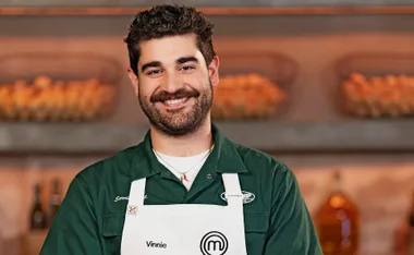 Vinnie Gibaldi wearing his white apron in the MasterChef Australia kitchen.