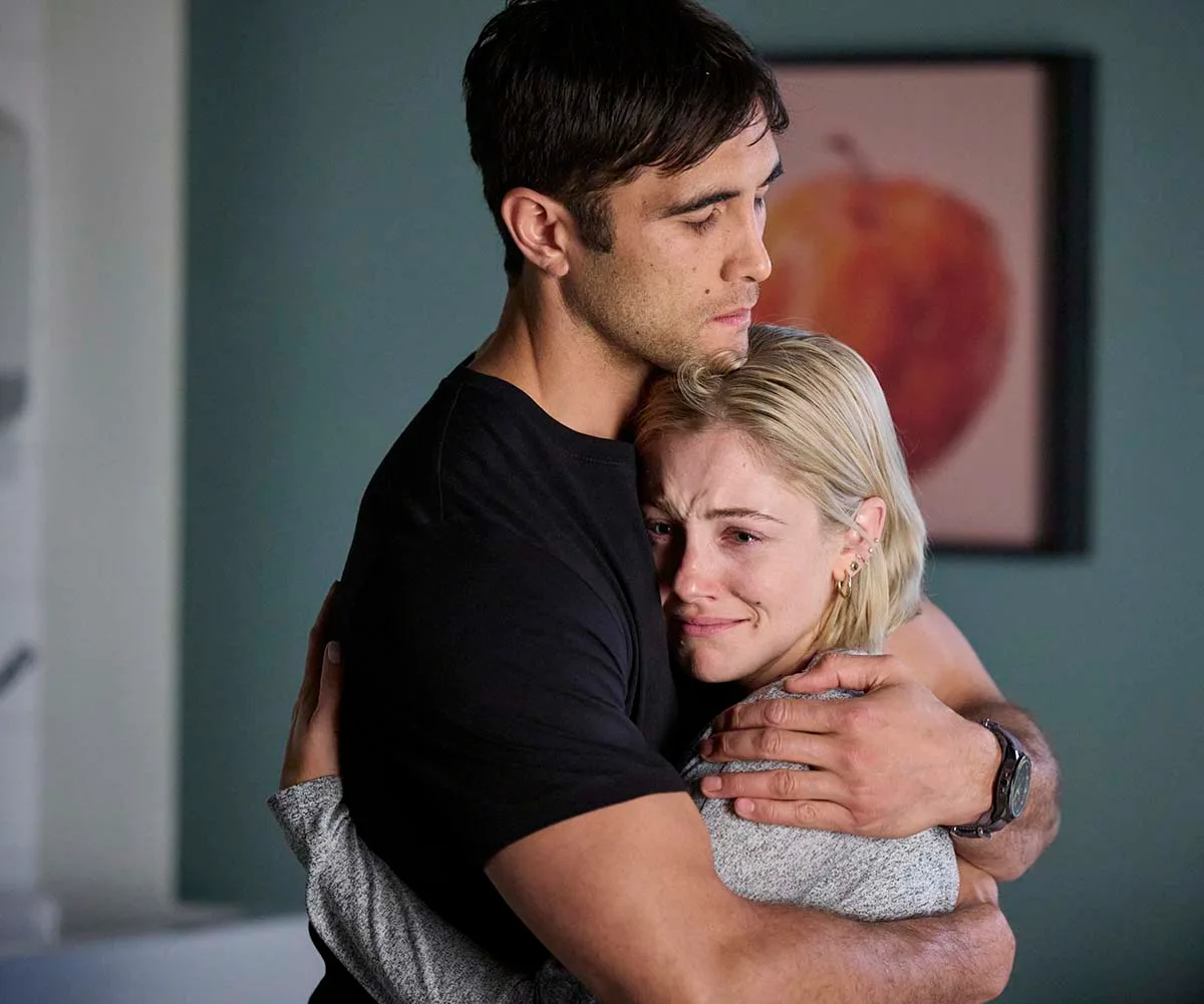 Jessica, in character as Harper, is hugged by Ethan Brown, in character as Tane, on the set of Home And Away