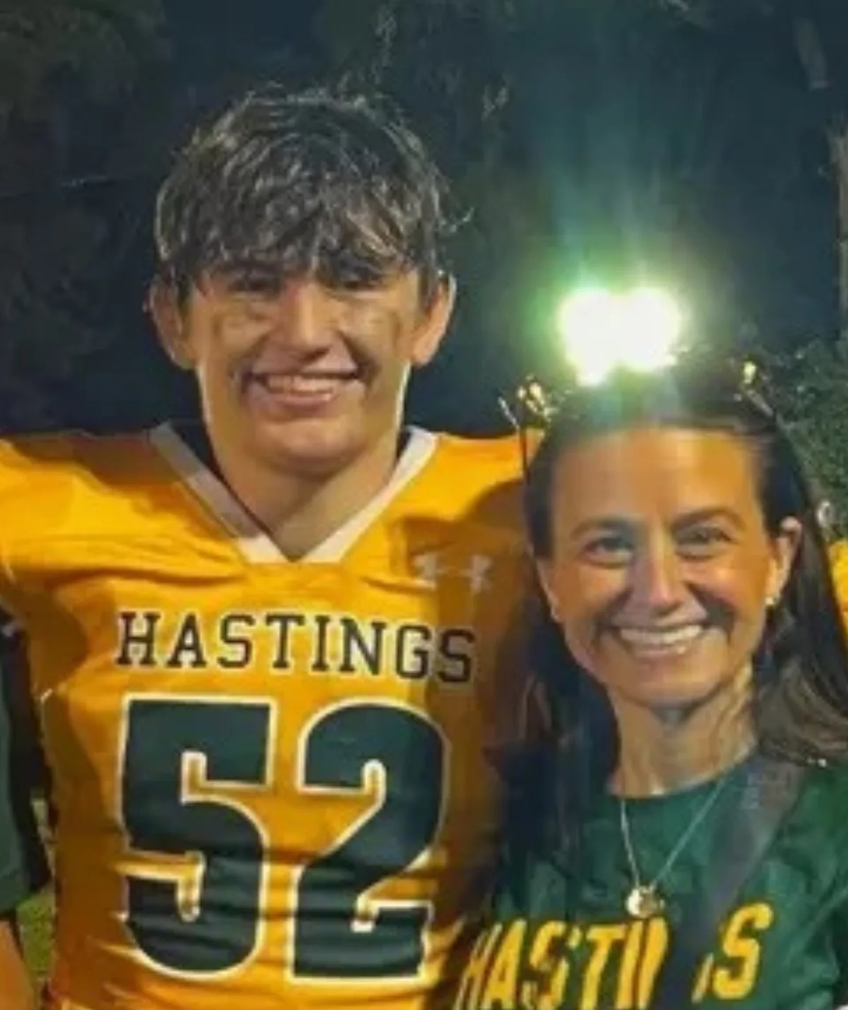 A boy and woman in American football tops smiling