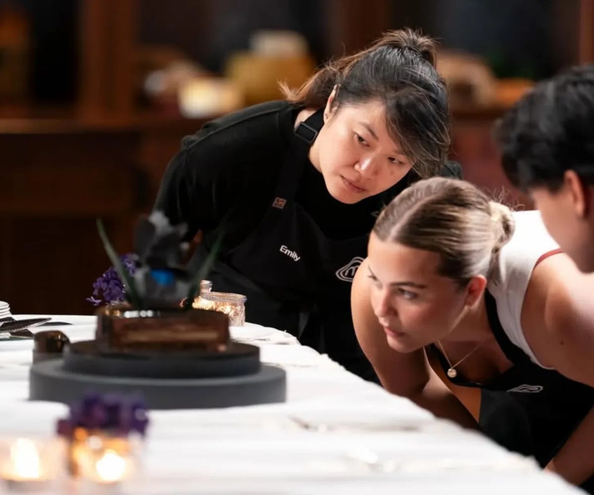 MasterChef Australia's Emily, Grace and Aaron gazing at Kirsten Tibball's chocolate iris dessert.