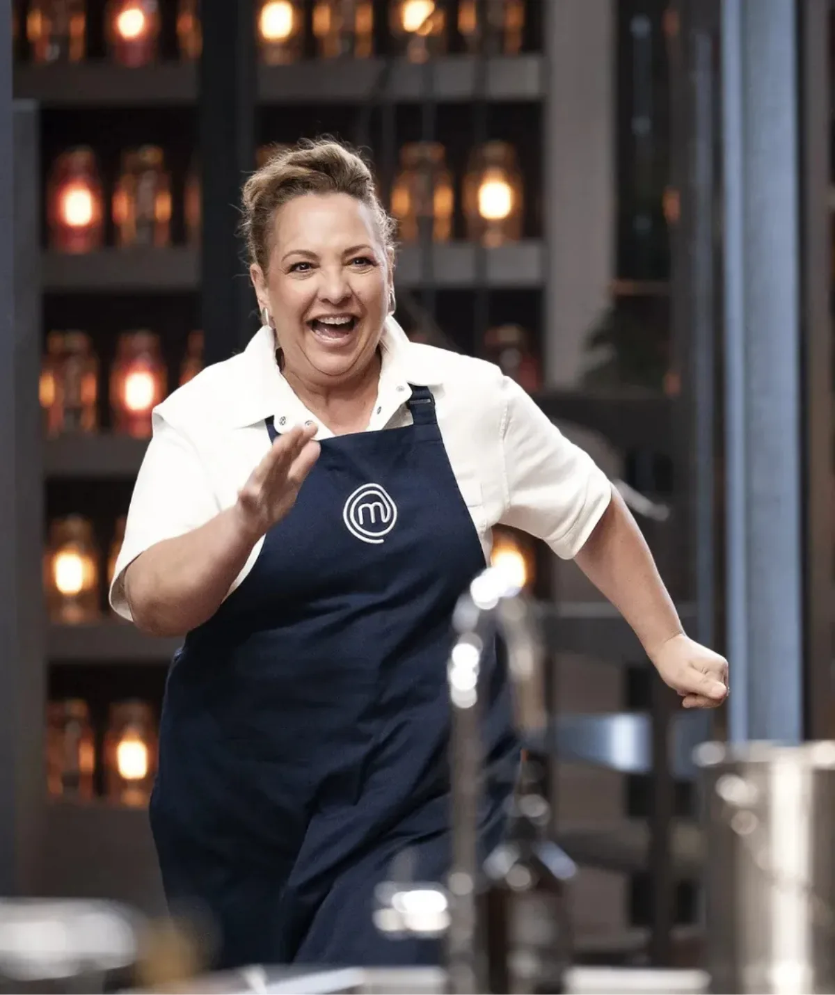 Lydia Kamperos running in the MasterChef Australia kitchen for the team relay challenge.