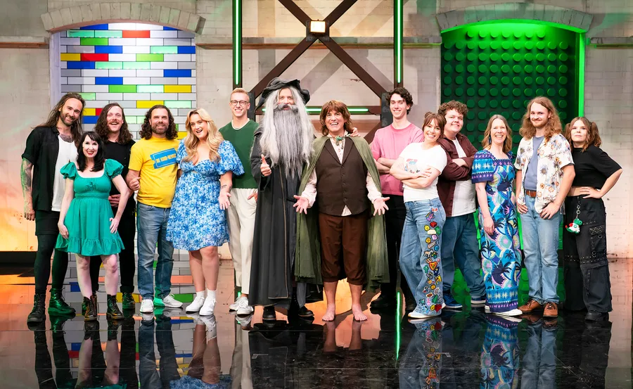 The cast of Lego Masters Bricktacular 2026 with Hamish Blake and Brickman dressed as Gandalf and Frodo.