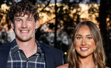 Farmer Zac stands next to Miranda outside at night