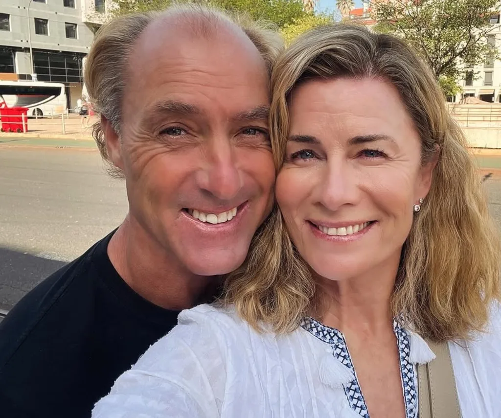 A man and a woman smiling to camera
