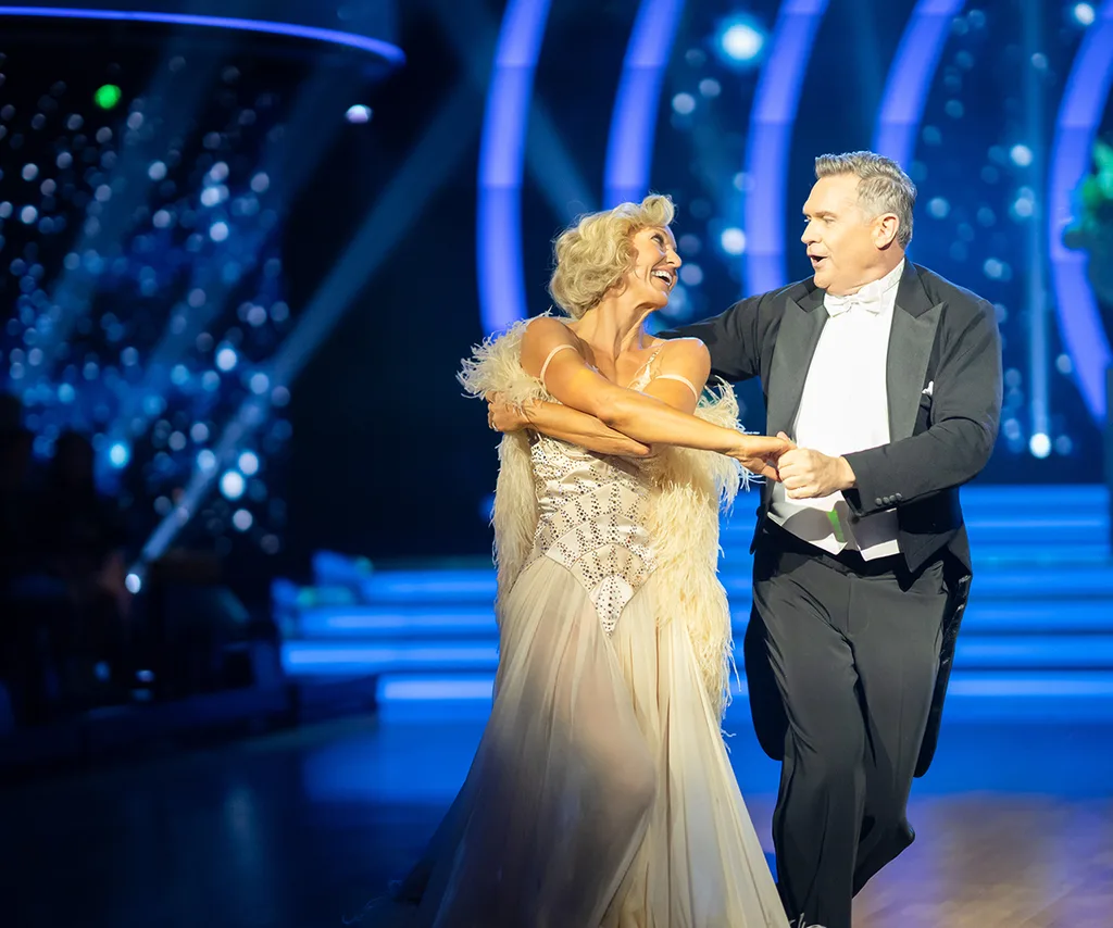 Michael Usher dancing with his partner on the DWTS stage.
