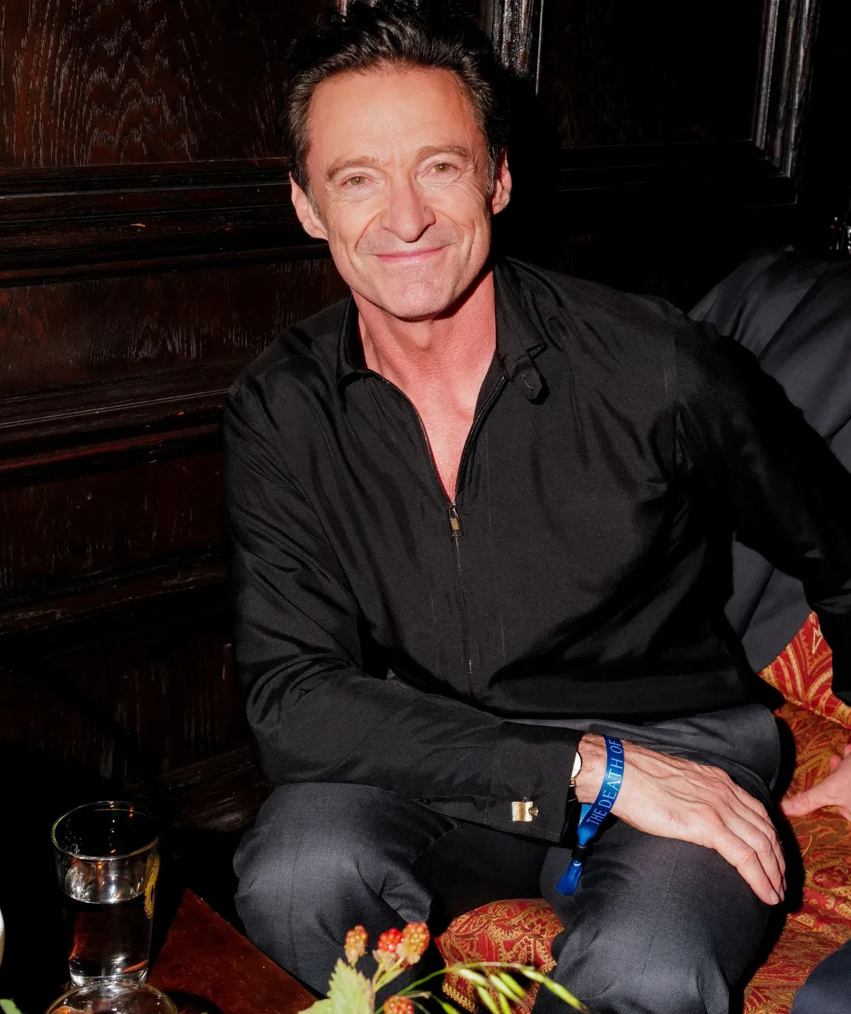 Hugh Jackman sitting alone 