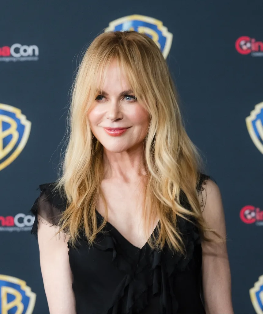 A blonde woman smiling.