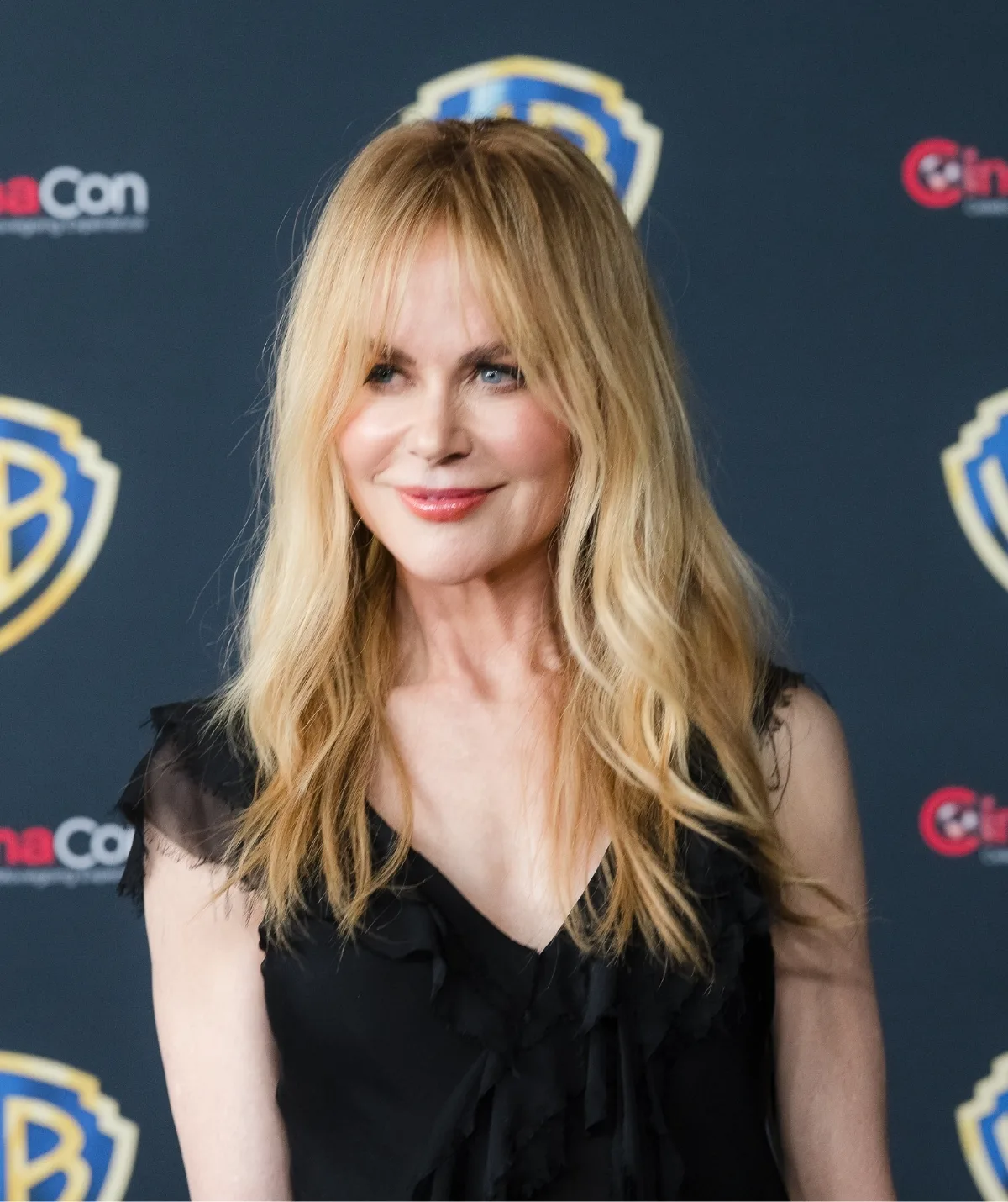 A blonde woman smiling.