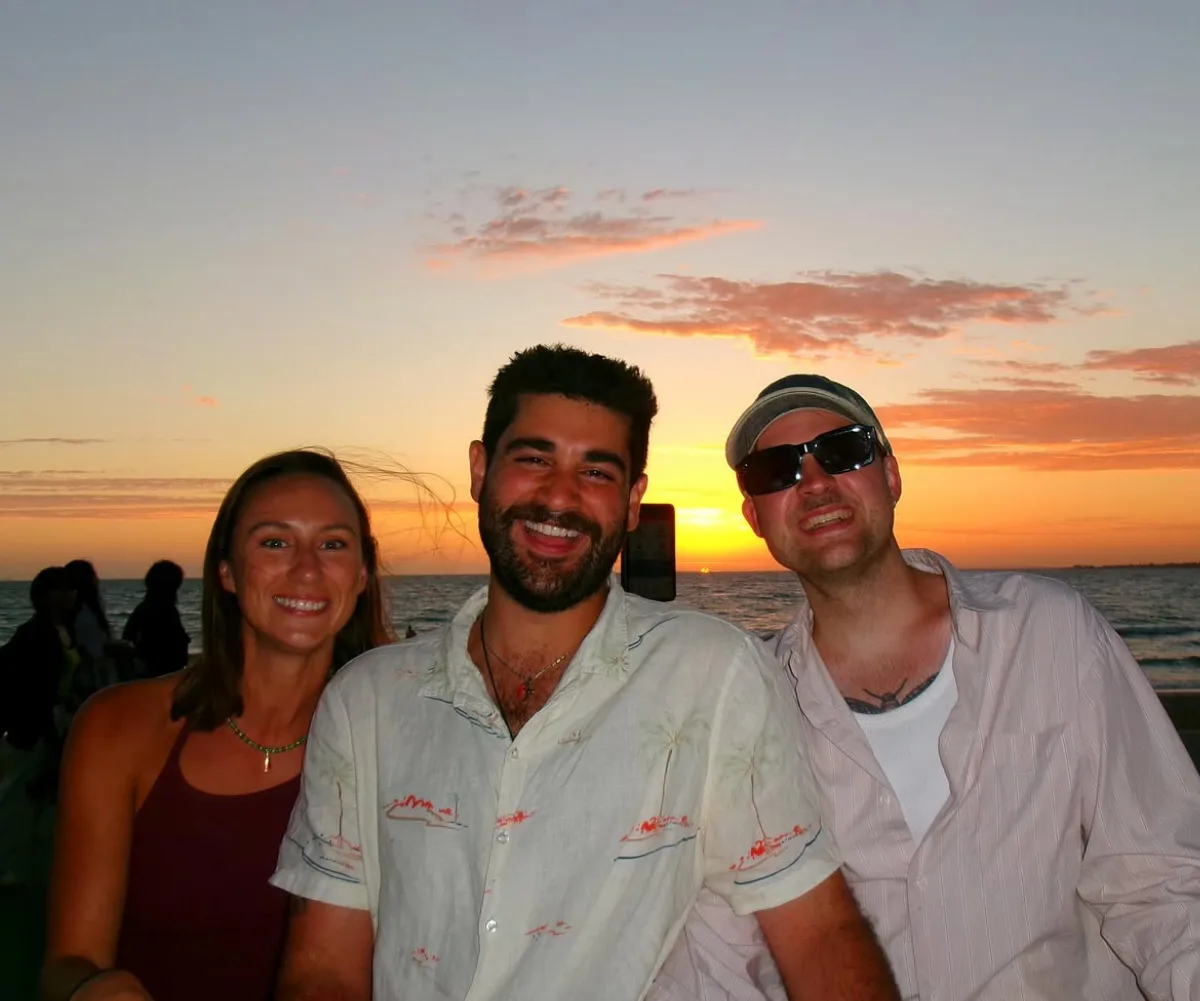 Annabel, Vinnie and Casper from MasterChef Australia standing in front of a sunset.