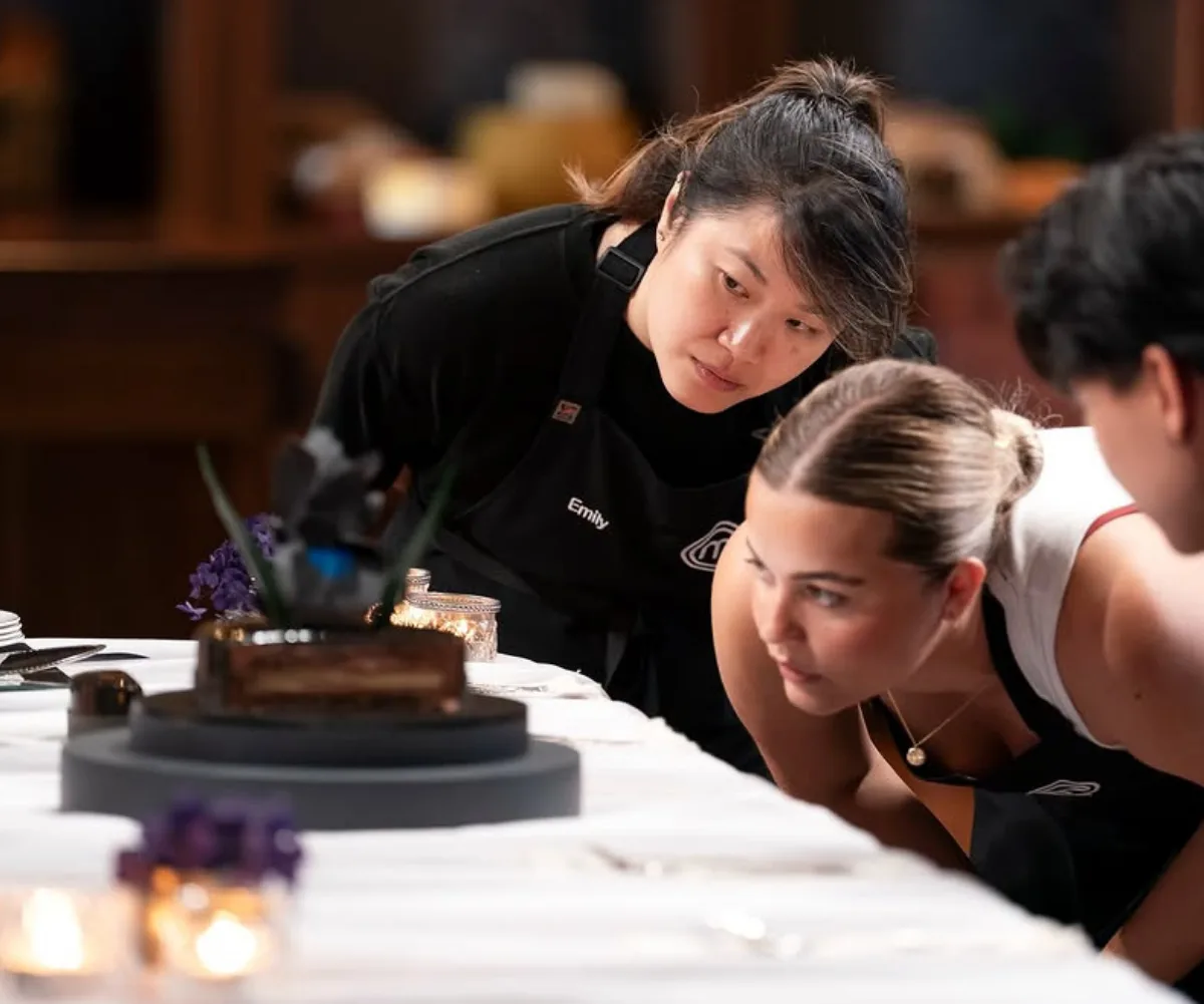 Emily Sue and Grace King looking at Kirsten Tibballs pressure test entremet.