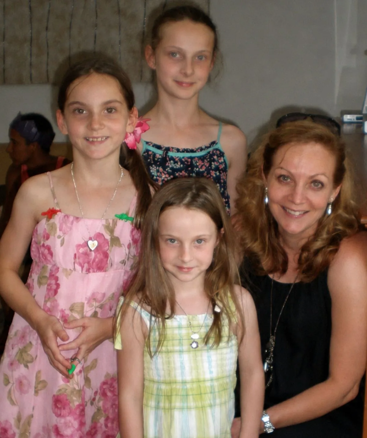 Allison Baden-Clay with her three young daughters smiling to camera.