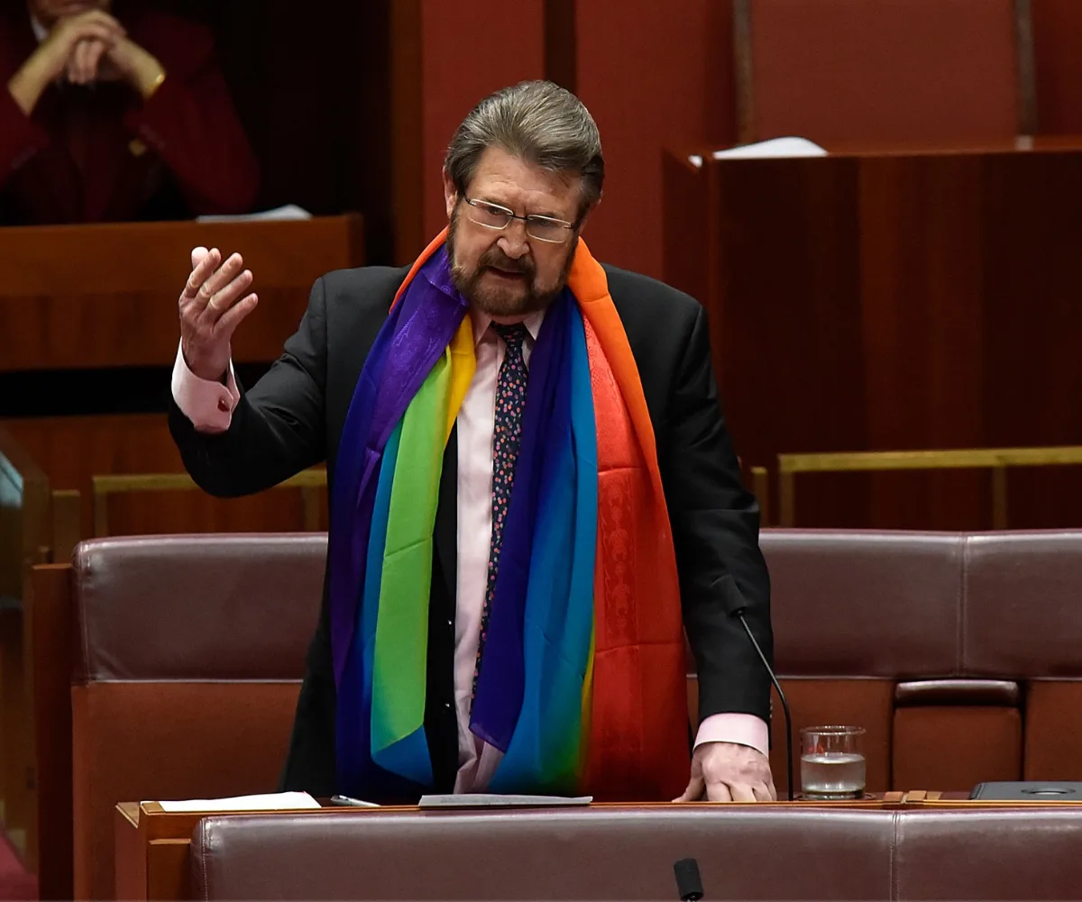 Derryn Hinch with a rainbow flag on in parliament 