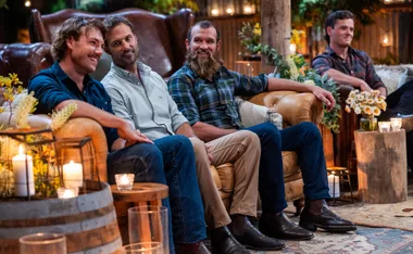 The five farmers are sitting on chairs in a row
