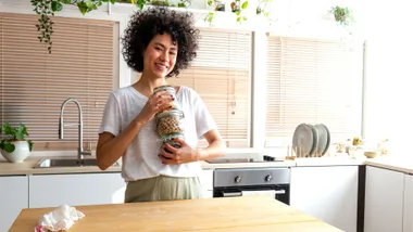 A WOMAN WITH JARS OF GRAINS