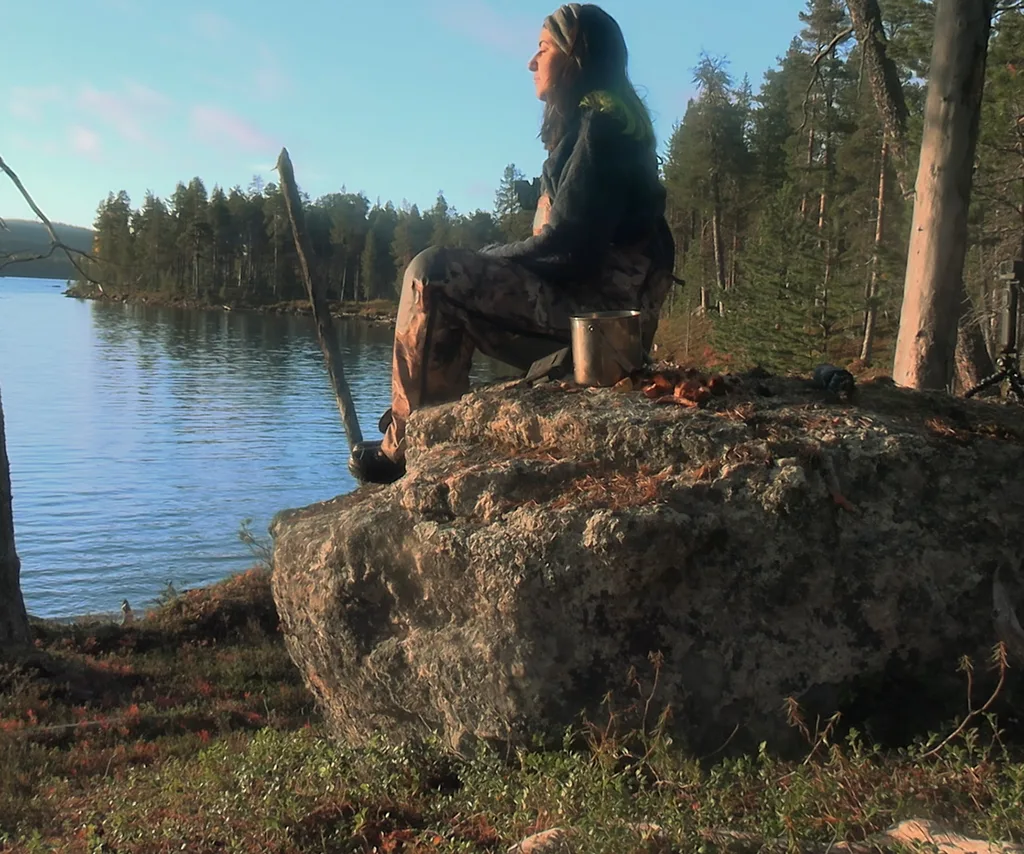 Alyce in episode two of Alone Australia sitting by the lake.