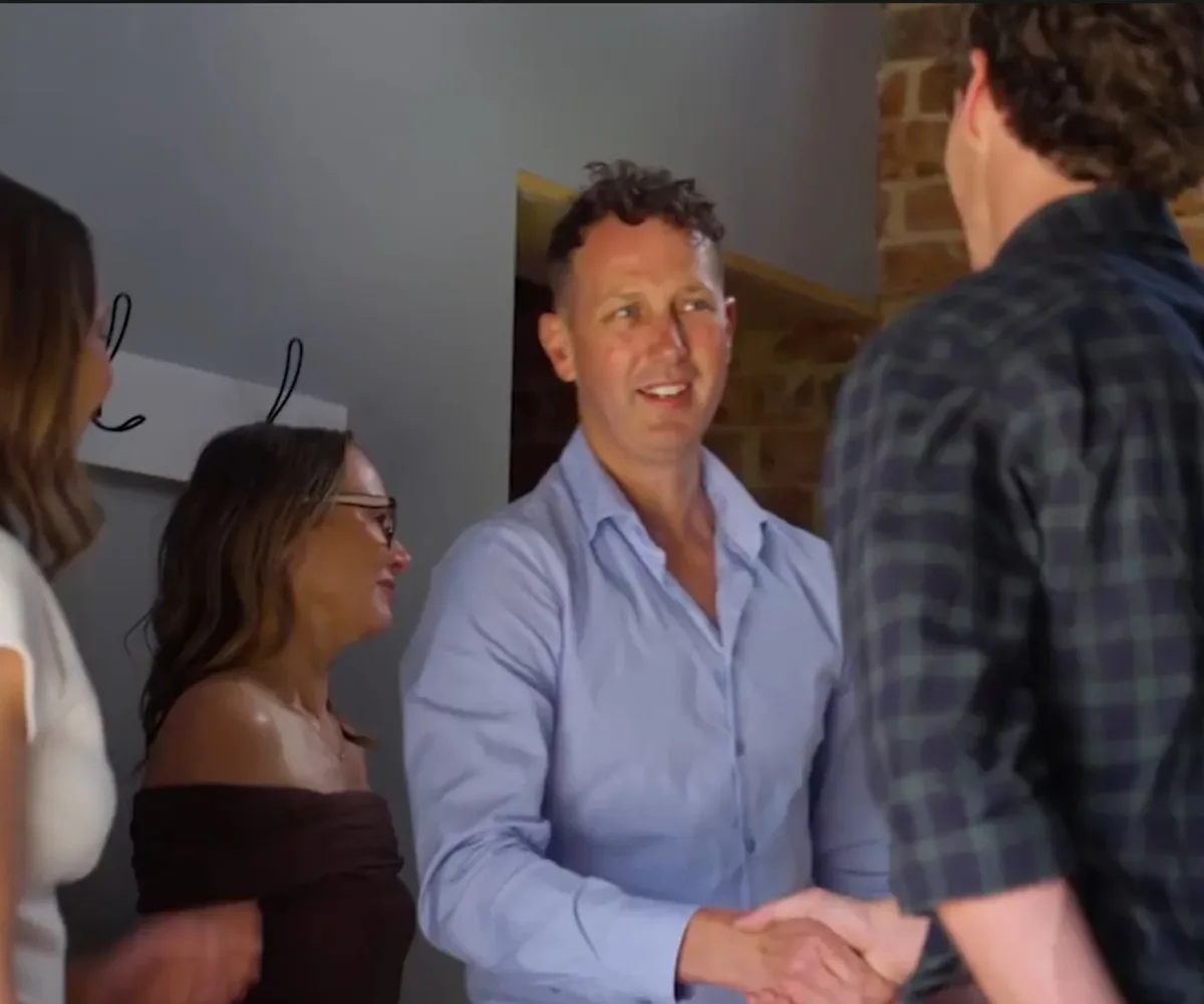 Zac shakes hands with Mieke's dad