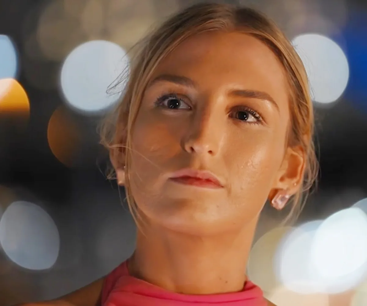 A close-up of Keeley's face, looking questioning