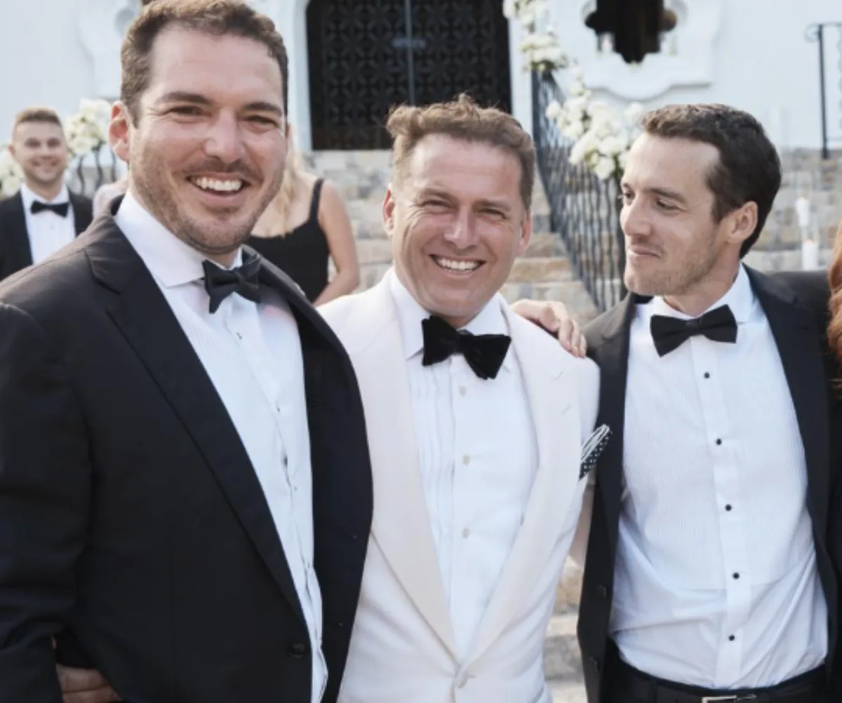 Peter, Karl and Tom Stefanovic smile while wearing suits 