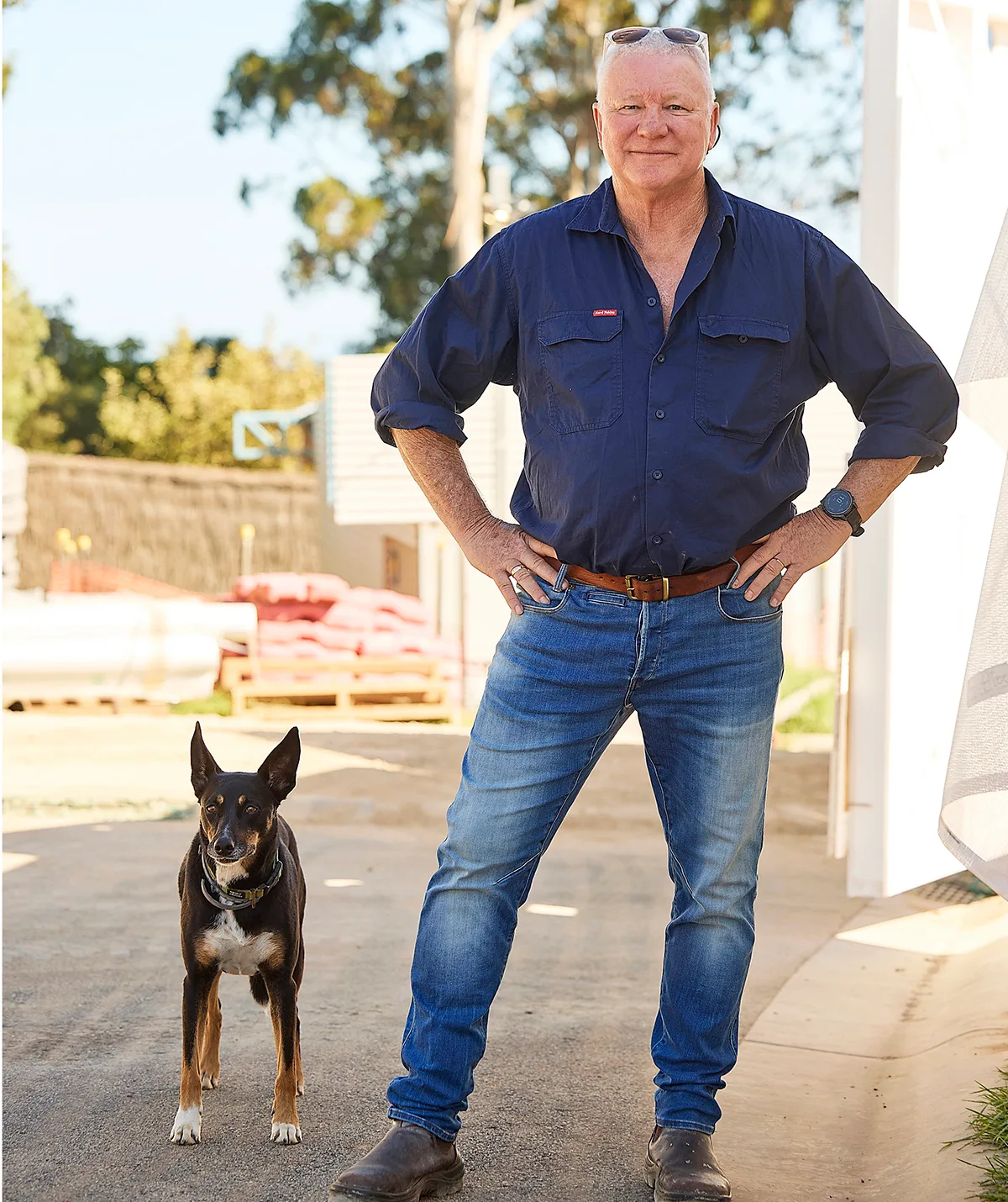 Scott Cam standing on site of The Block with his dog.
