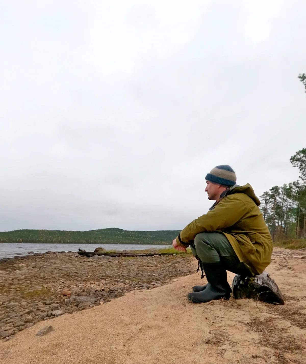 Dylan from Alone Australia looking out to the lake he is camped by in season four.