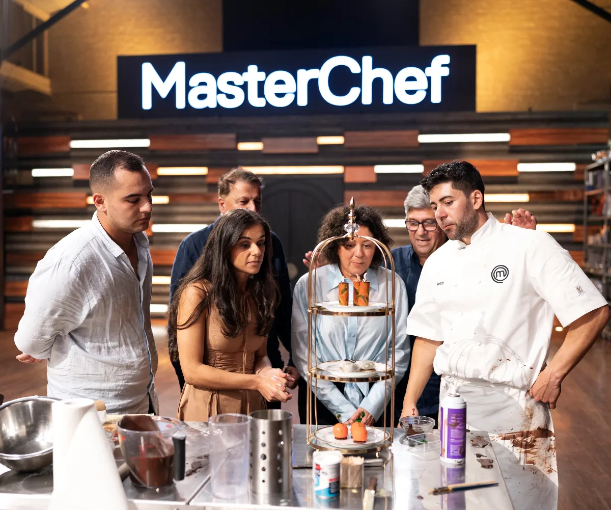 Petro Papathomas surrounded by his family looking at the finale dish he created.