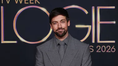 Lincoln Younes in a grey suit in front of the TV WEEK Logie Awards 2026 sign.