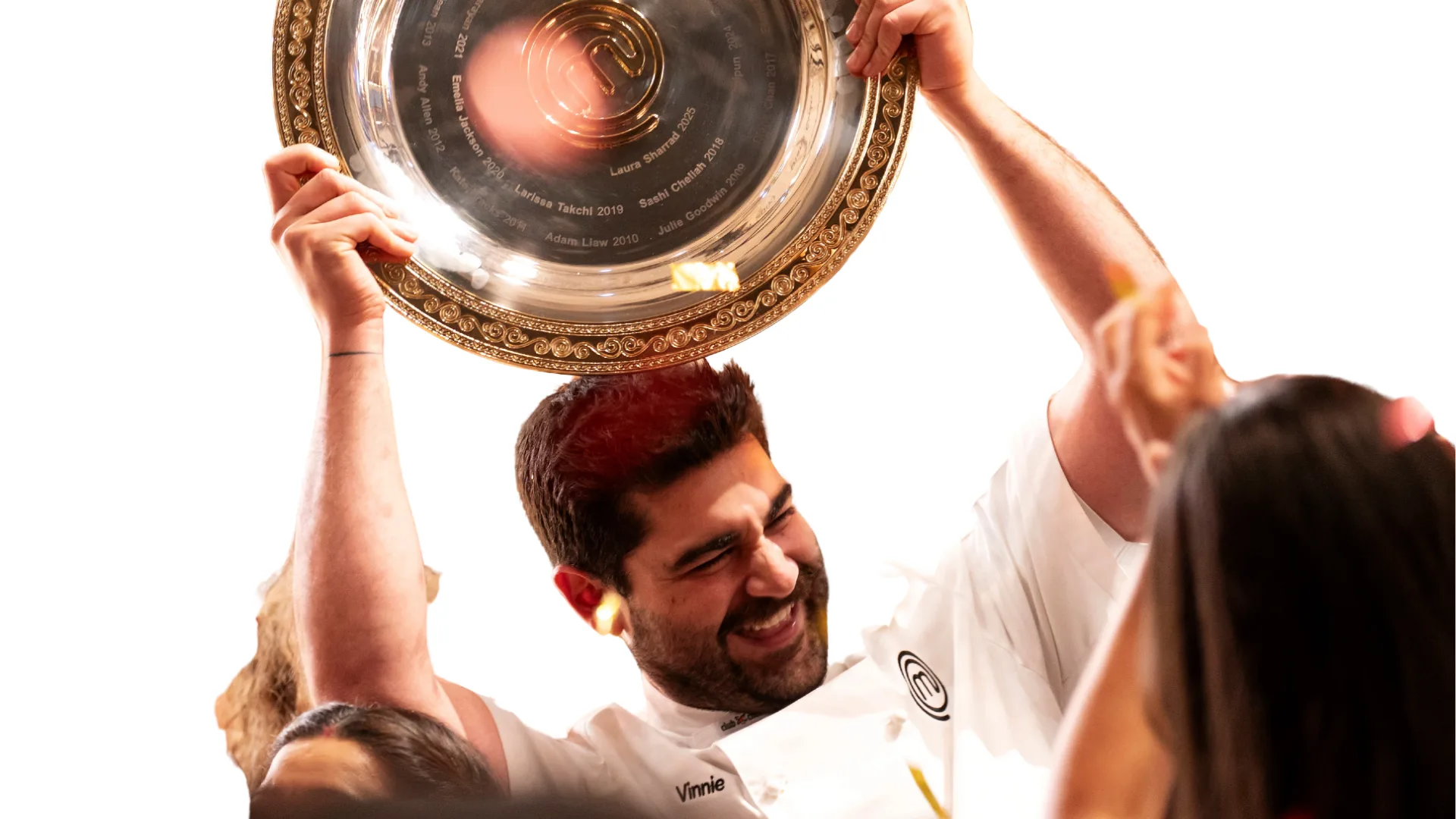 Vinnie Gibaldi smiling holding the MasterChef Australia trophy.