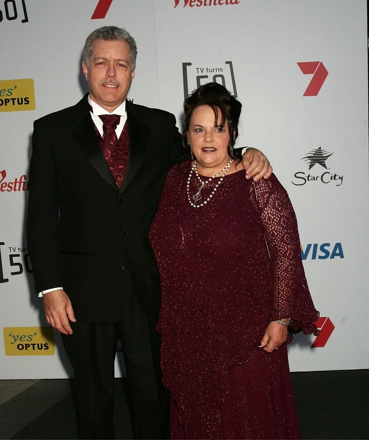 A man and a woman stand next to each other.