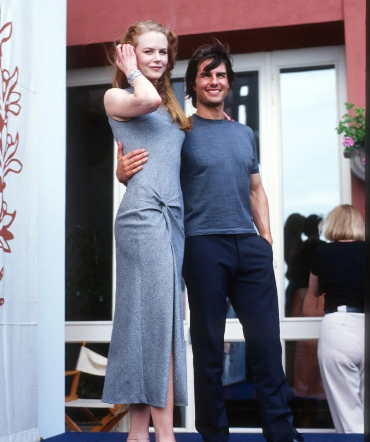 Nicole Kidman stands smiling with her then husband Tom Cruise.