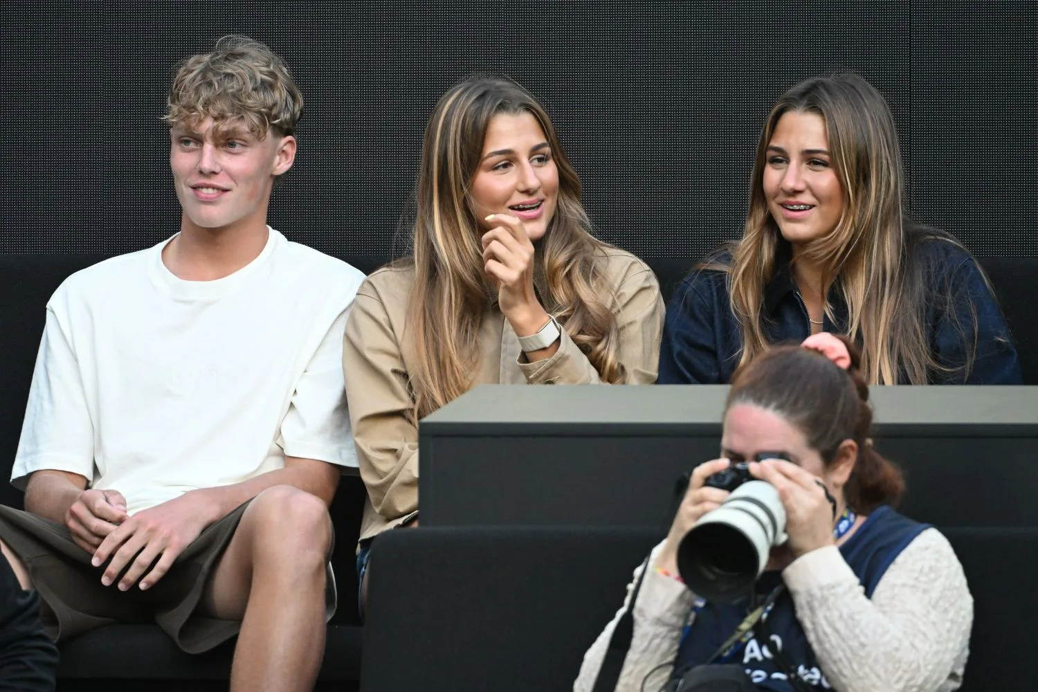 Cruz Hewitt sits alongside Myla and Charlene Federer at the Australian Open.