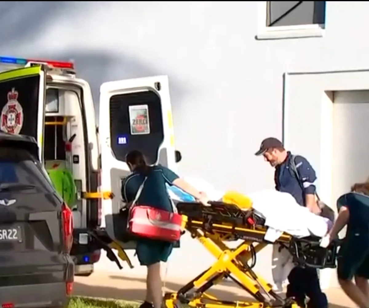 Paramedics wheeling away Brooklyn on a stretcher