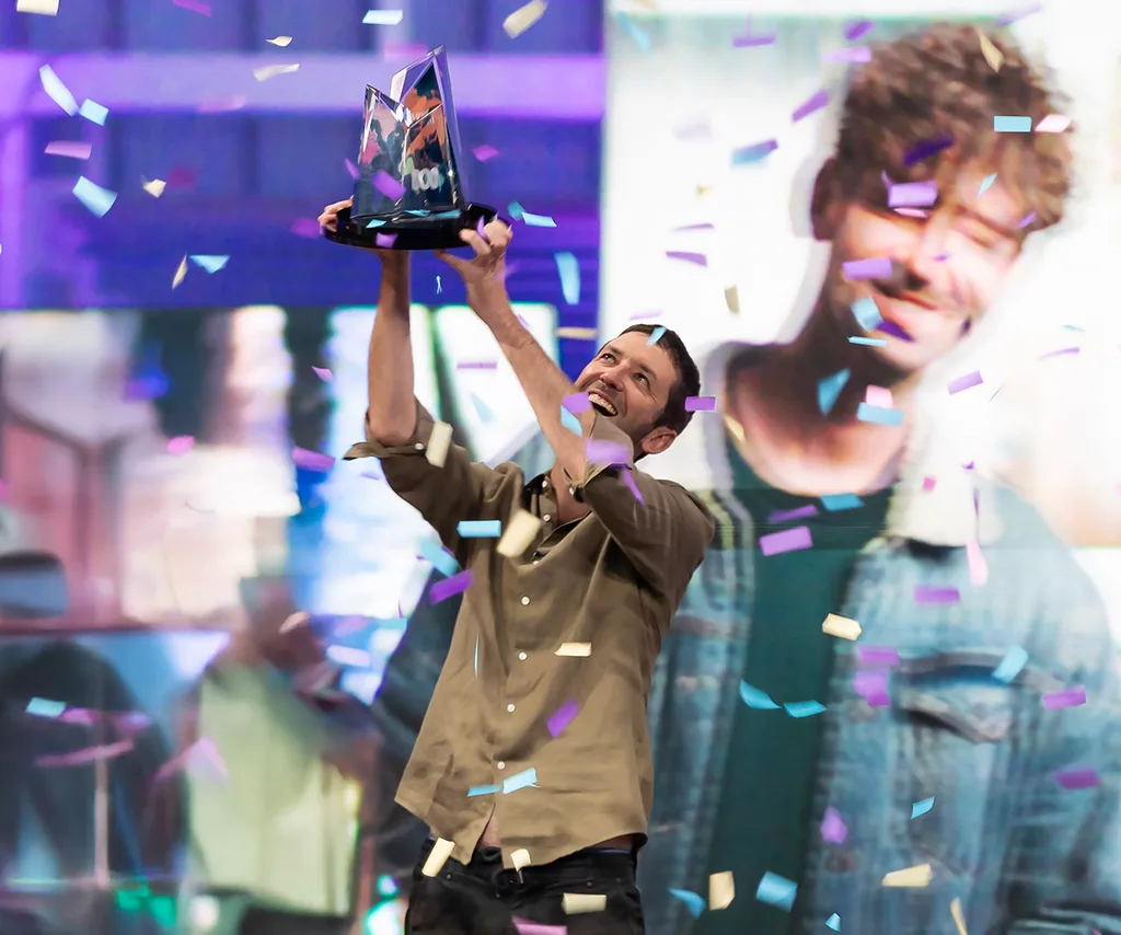 Elliot holds the winner's trophy