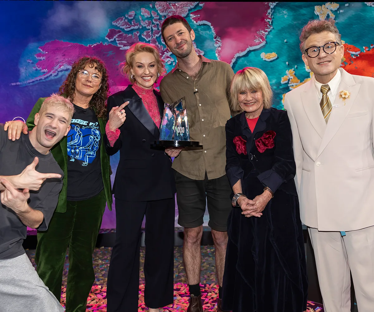 Elliot on stage with the host and judges