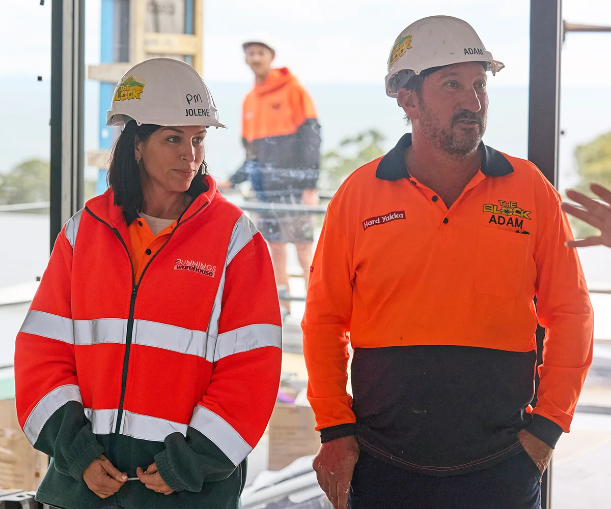 Adam and Jolene on site of The Block 2026 in orange hi vis.