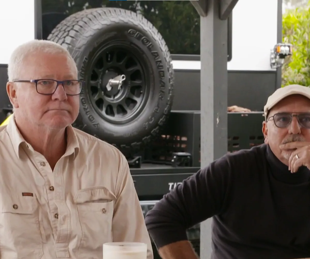 Scotty Cam and The Block executive producer Julian Cress at a table in the back of the share house.