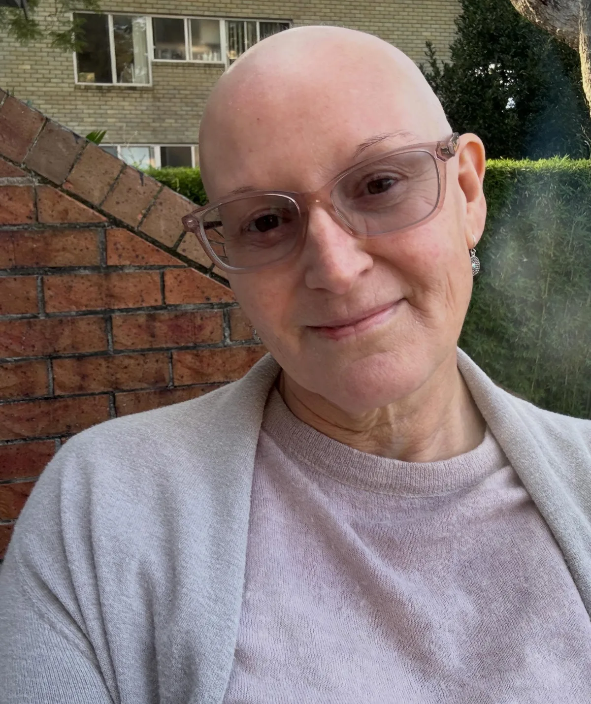 Cass Thorburn has been in treatment for a rare kind of breast cancer - pictured smiling in selfie with no hair