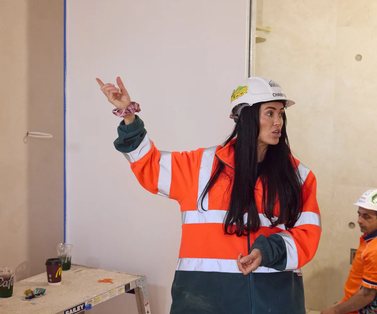Chantel on The Block site with her arm in the air looking frustrated.
